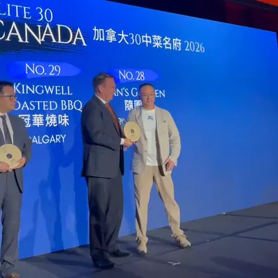 Receiving the Elite 30 Canada trophy on stage at the awards ceremony