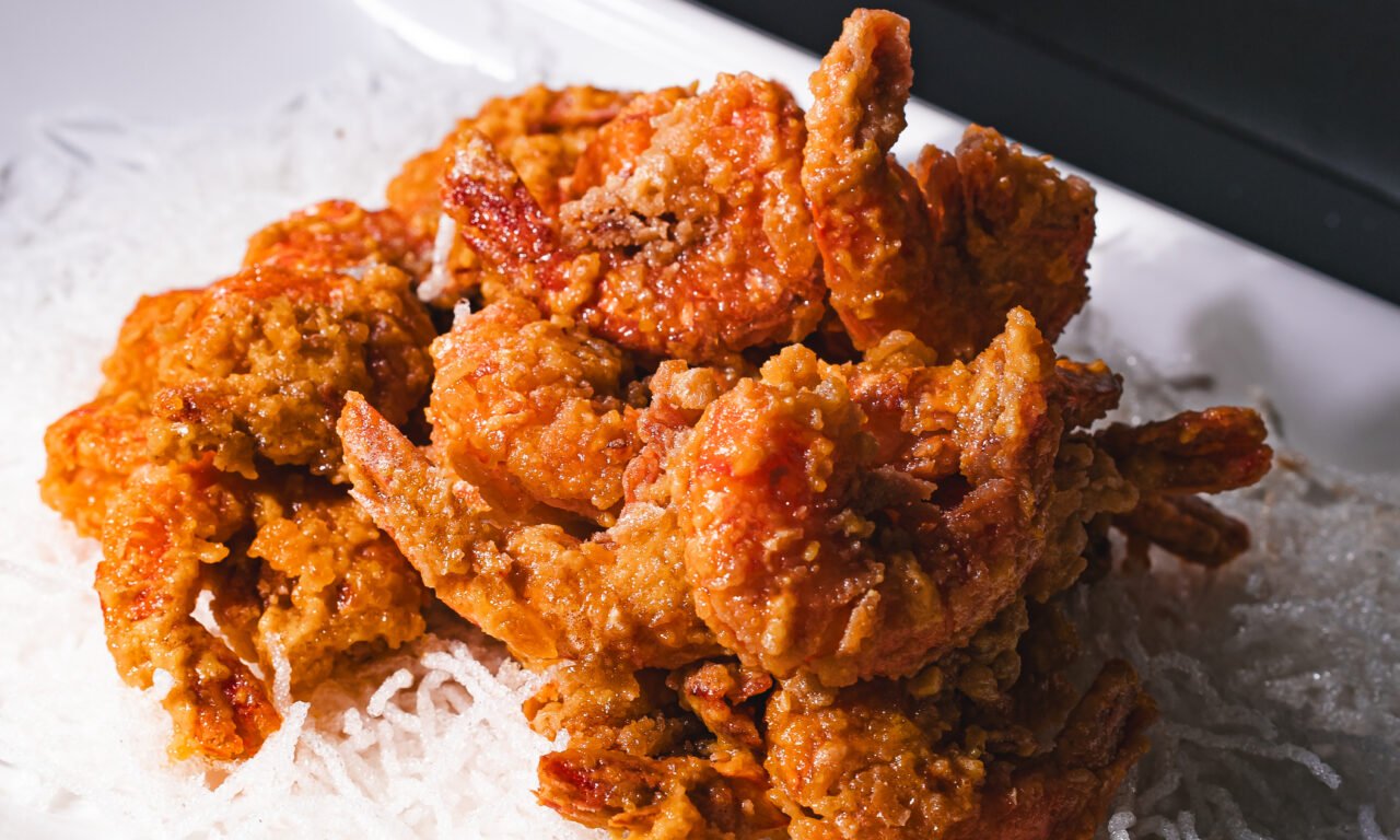 Golden crispy prawns served over a nest of crisp rice vermicelli