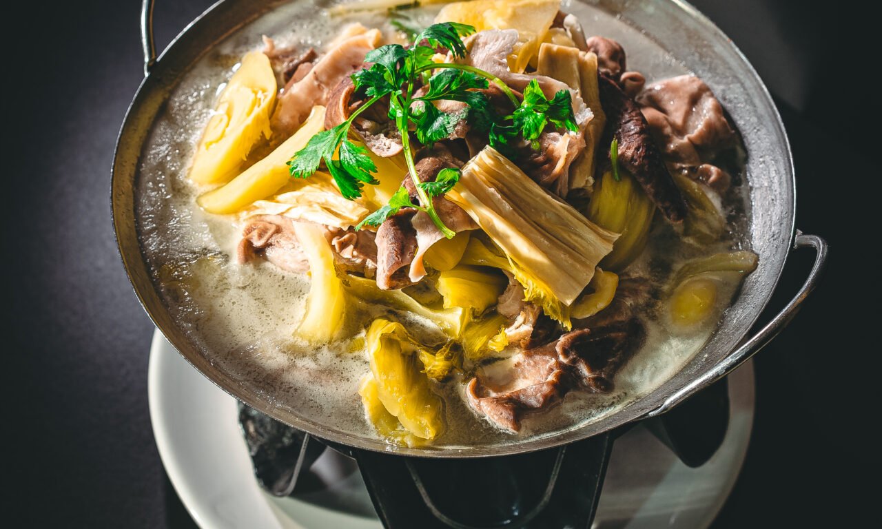 Sliced pork tripe with pickled cabbage and bamboo in a milky broth
